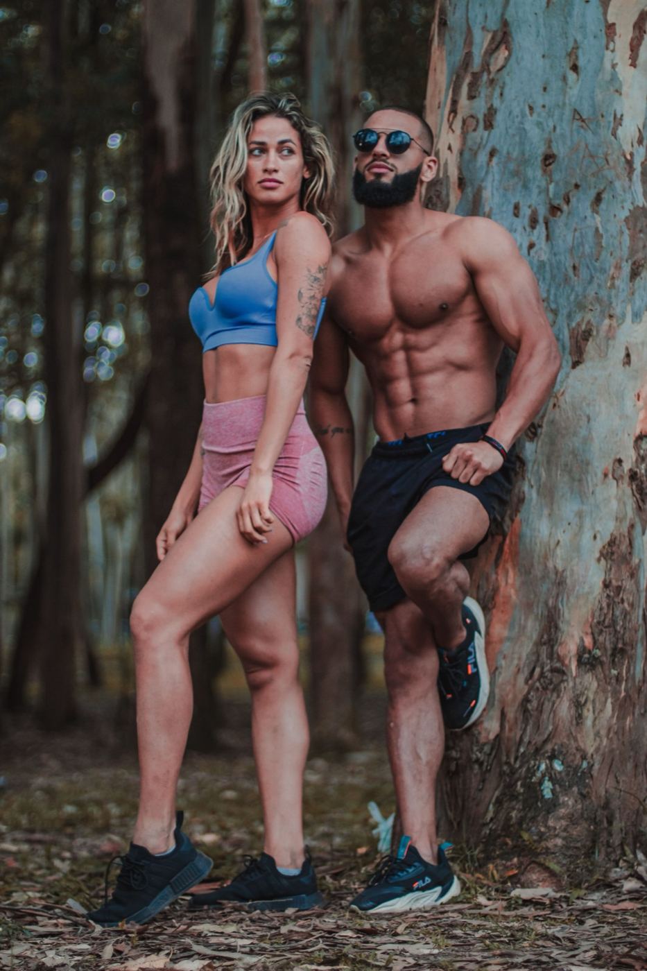 Couple standing among trees after a woodland run