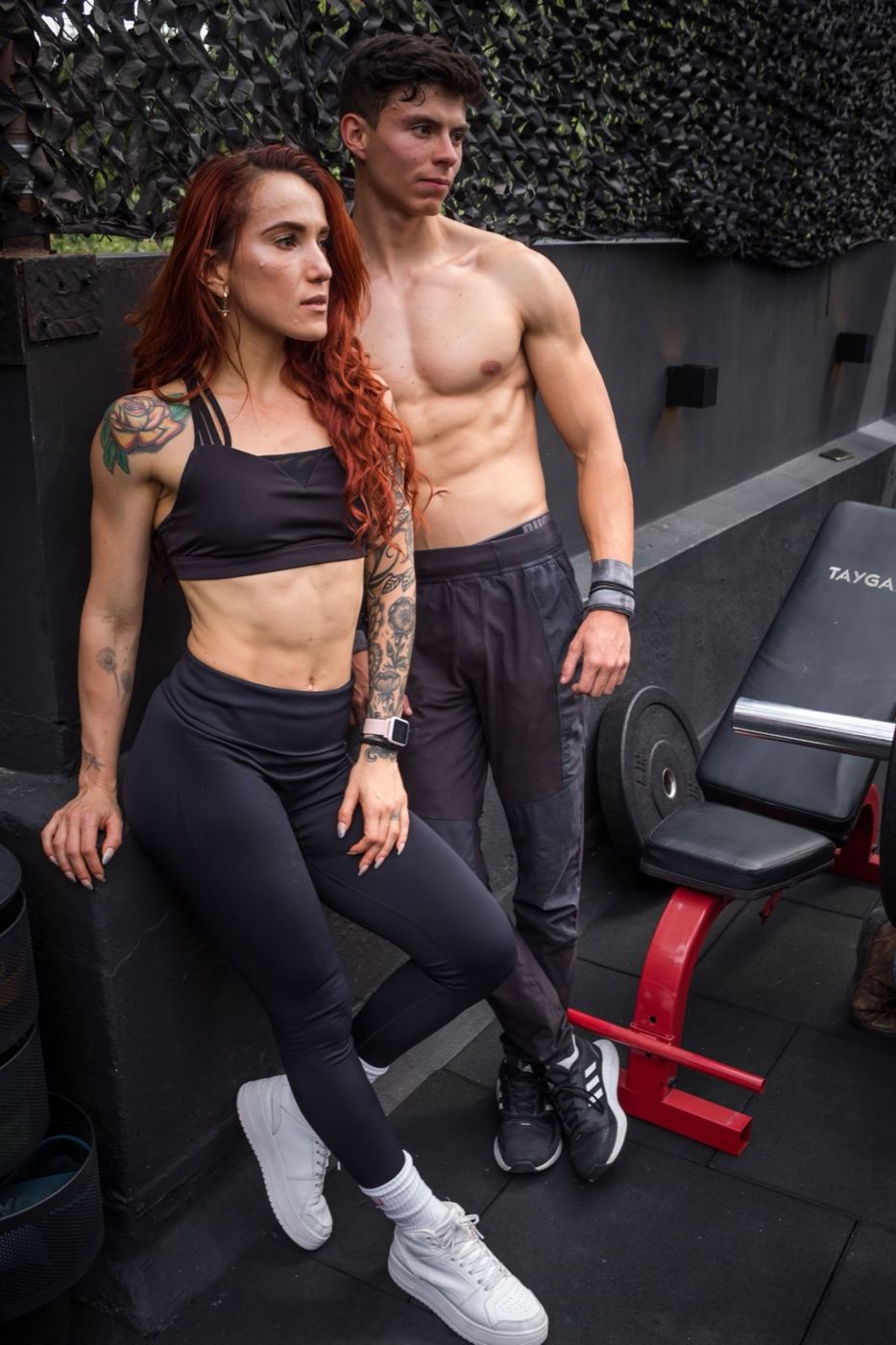 Couple in training gear standing together in a gym