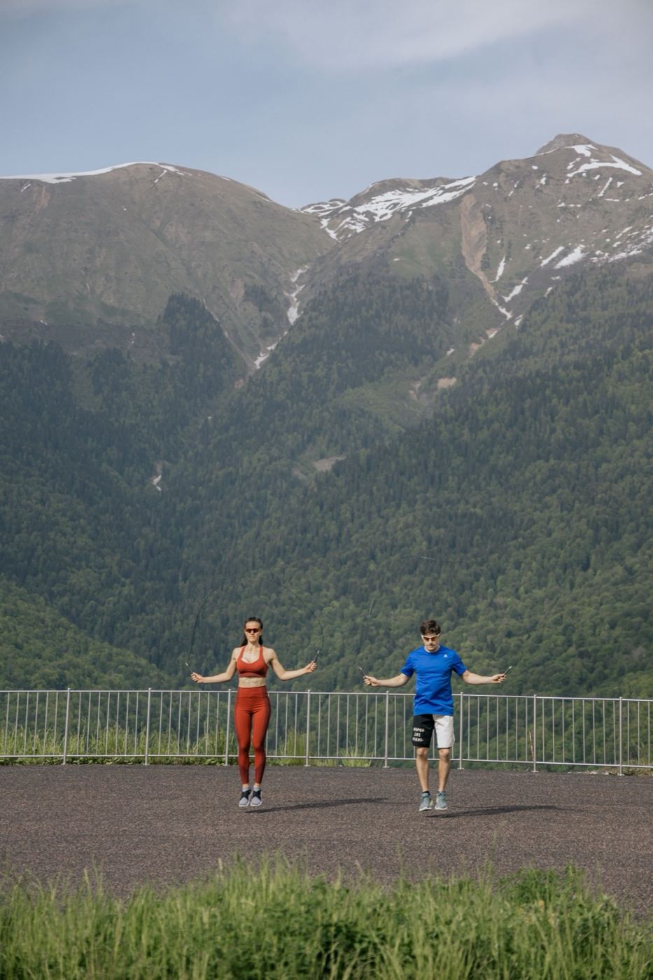 Couple standing at a mountain viewpoint after a hike