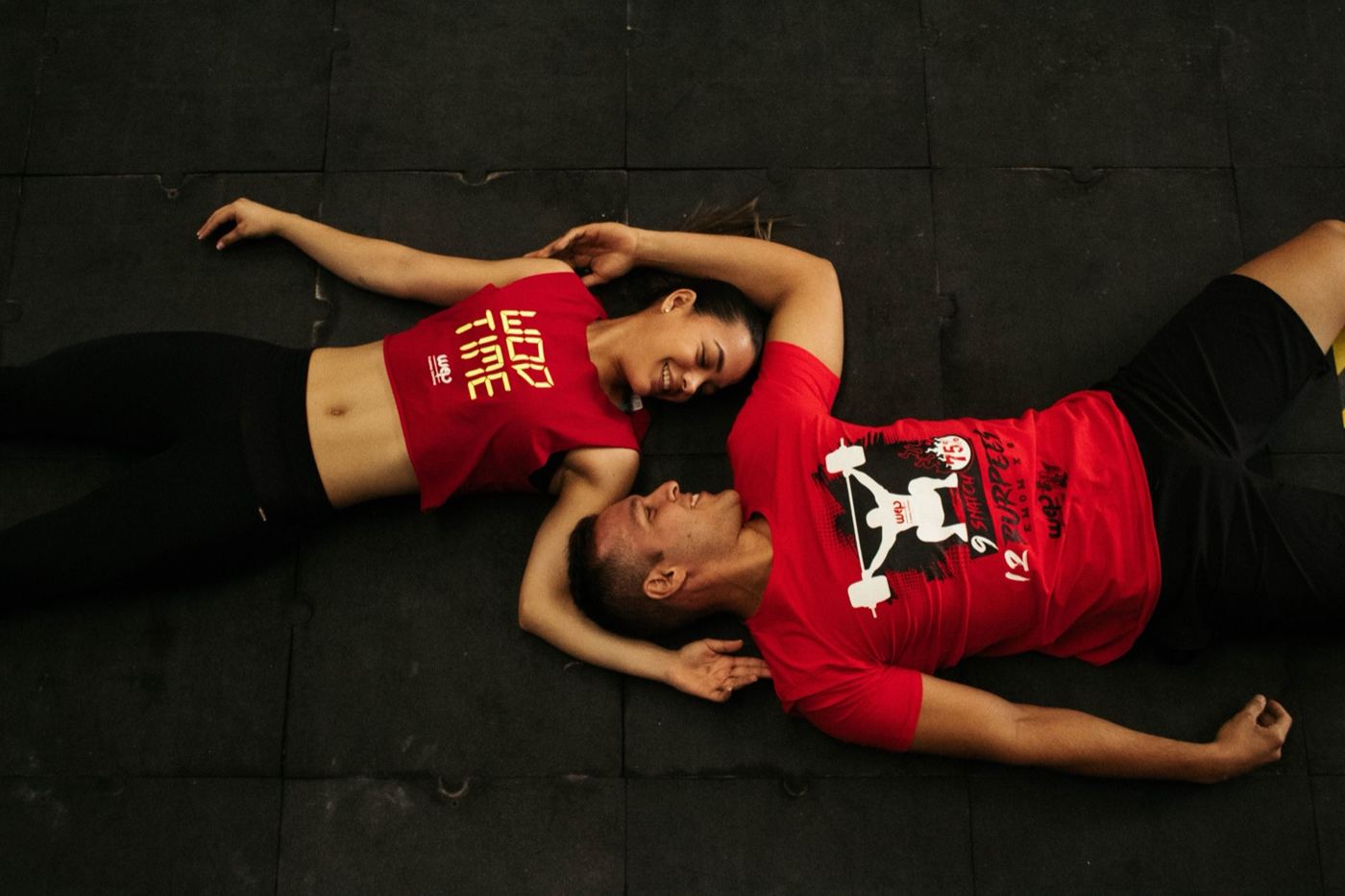 Couple lying on a mat resting after a workout