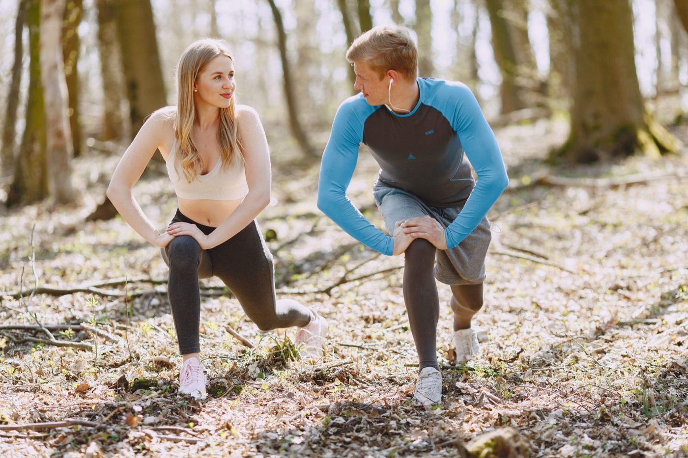 Couple warming up together before a run through the woods